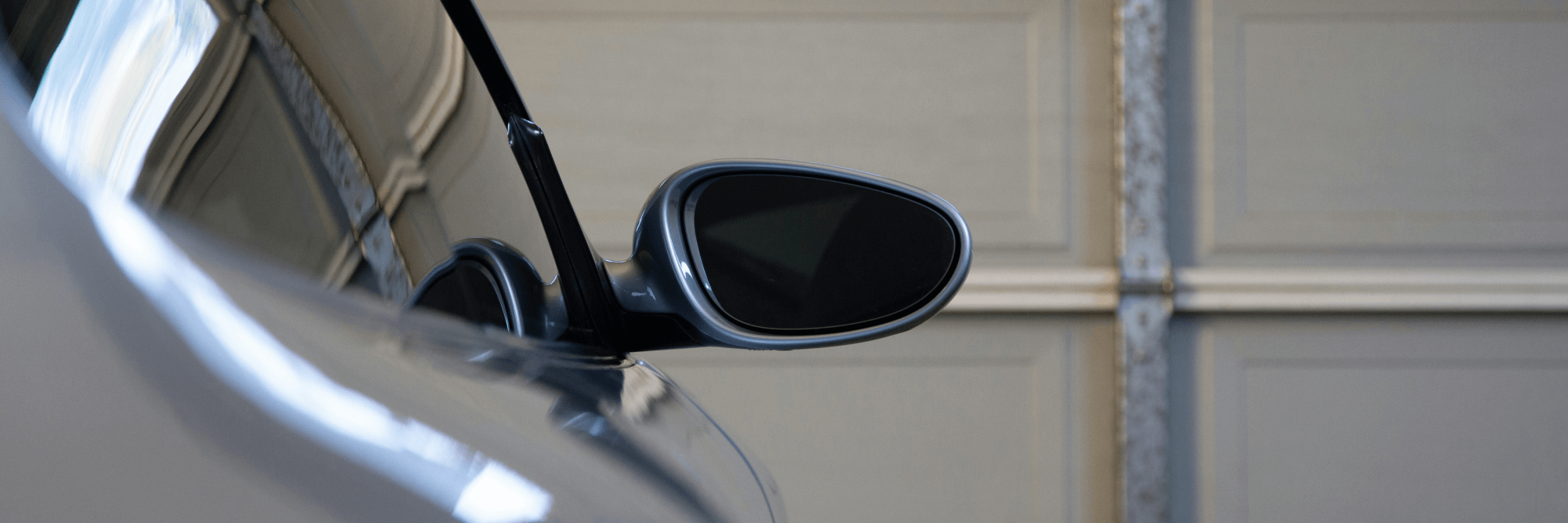 Buying garage door opener – Someone using a remote to open a garage door